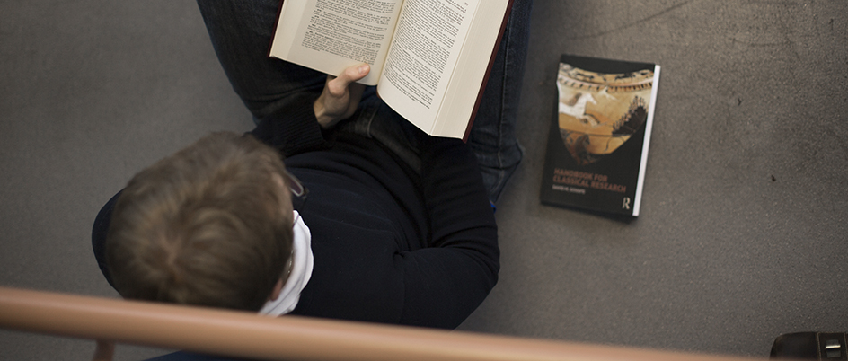 Graduate student reading a book