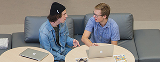 Two undergraduate students on laptops