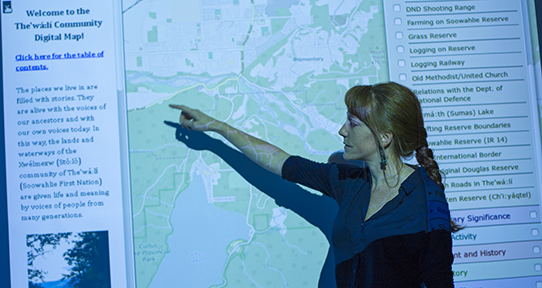 Sabina Trimble in front of a projected map