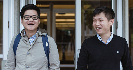 Two students outside of the library