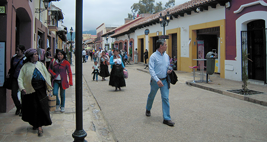 People walking through a street in San Cristolbal, Mexico