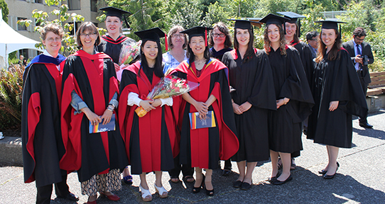Group of graduating students and faculty in convocation robes