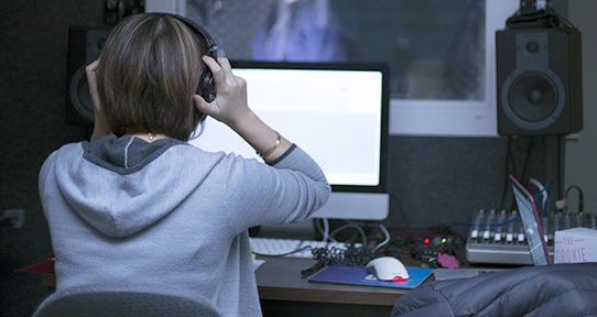 Student in a linguistics sound lab