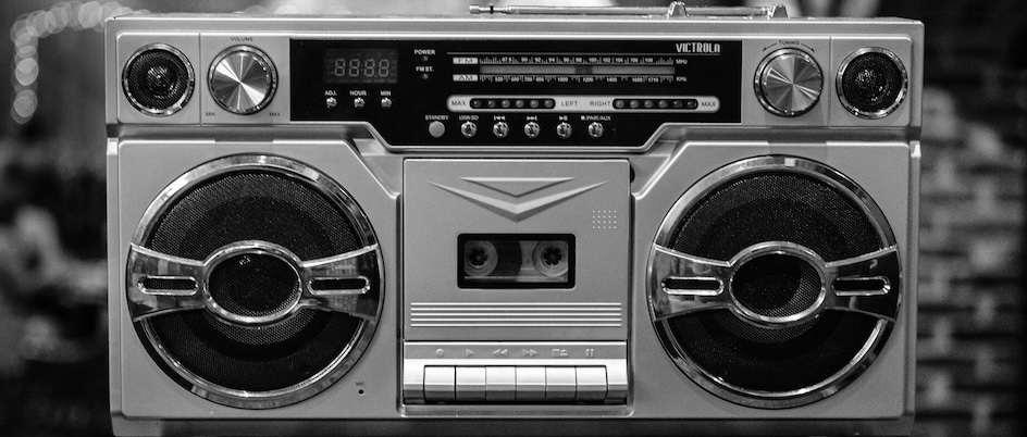 a boom box with a cassette deck, radio, and two speakers, all in black and white