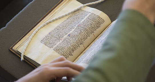 Close up of student working with a medieval manuscript