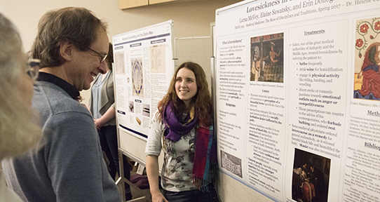 Student presenting her research poster