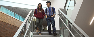 Undergraduate students walking down stairs