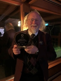 James accepting REACH award