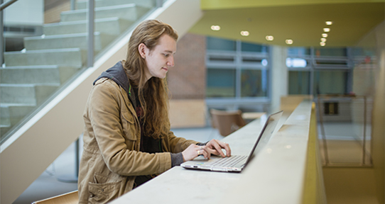 Undergraduate student Mark Taggesel on a laptop