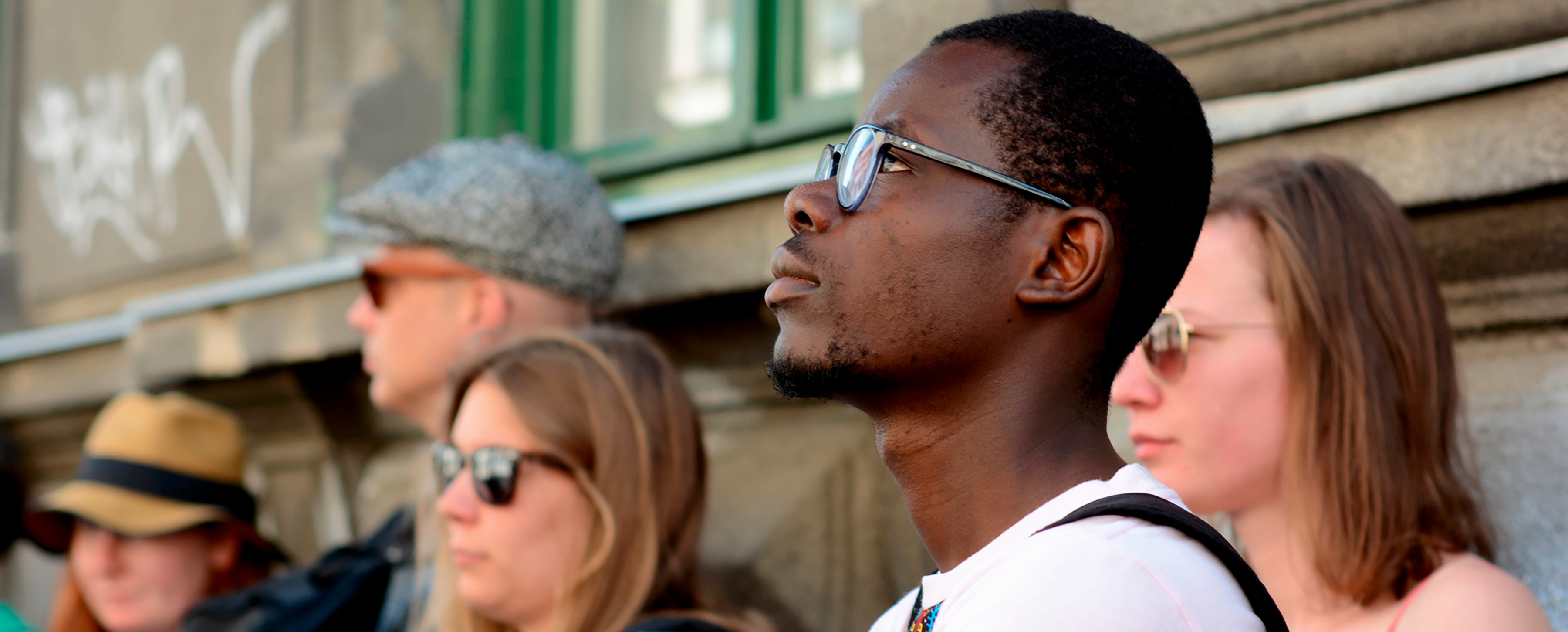 A Black student in a larger group of students on a field school.
