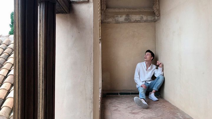 Elijah Ackerly is sitting in an old building in Spain.