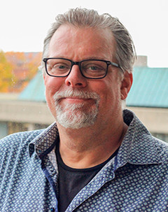 Matt Pollard, a man with grey hair and a beard.