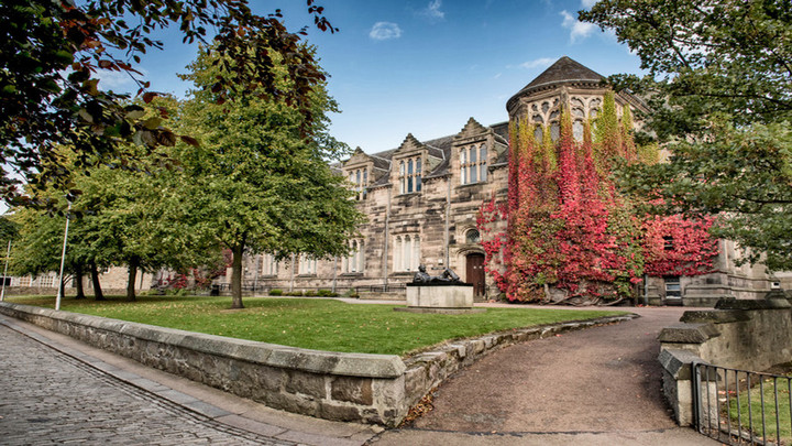 older building surrounded by trees and ivy