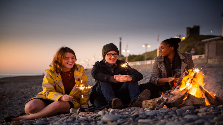 Students with sparklers on beach