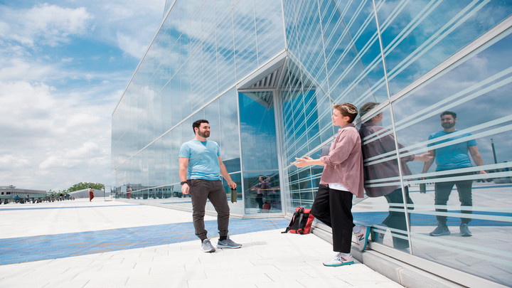 Glass building and two students