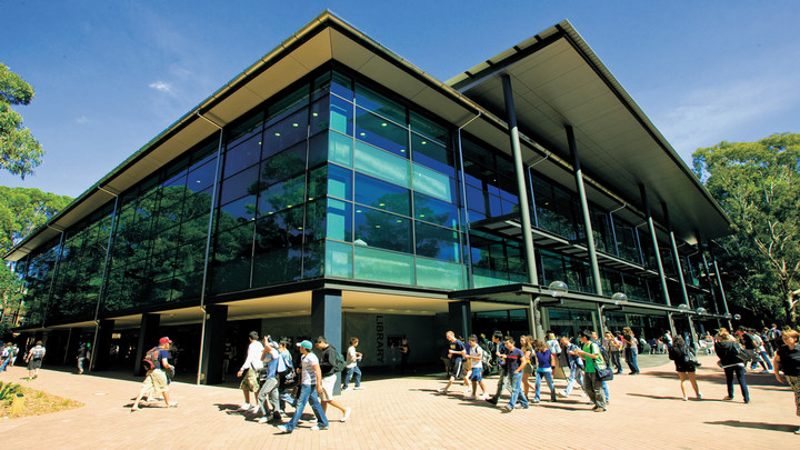 Students walk in front of the University of Wollongong campus library
