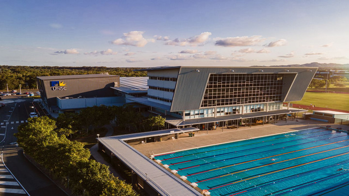 photo of a campus building and pool