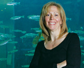 Cullon in front of a tank of young chinook salmon at the Shaw Ocean Discovery Centre in Sidney.
