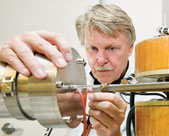 Pearson adjusts part of a mass spectrometer used to determine the identity of blood molecules.