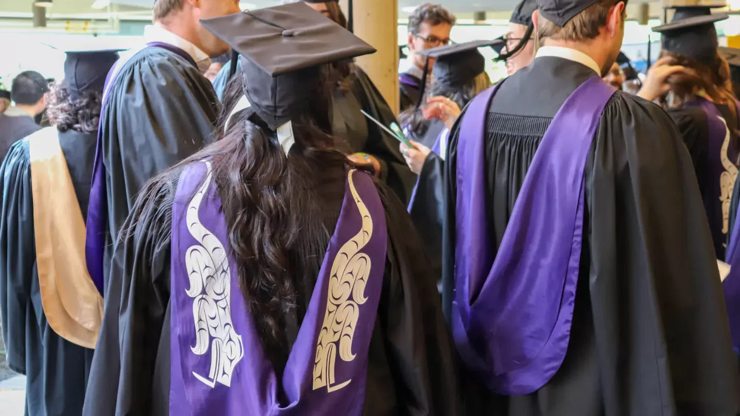 Coast Salish inspired purple robes are worn at a convocation reception