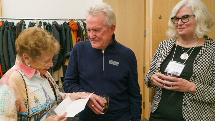 Anne Fraser receives a cheque for $100,000 from Judge Gregory Rideout