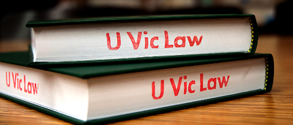 Library books stamped with UVic Law letters