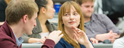 Two graduate students talking in a classroom