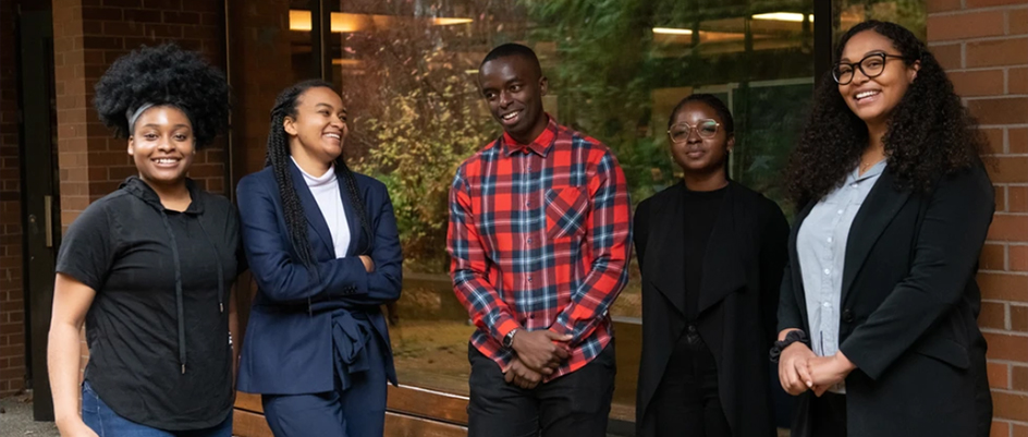 Students from the Black Professionals Leadership Program stand outside of the law building