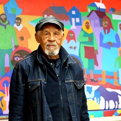 Artist standing in front of a painting