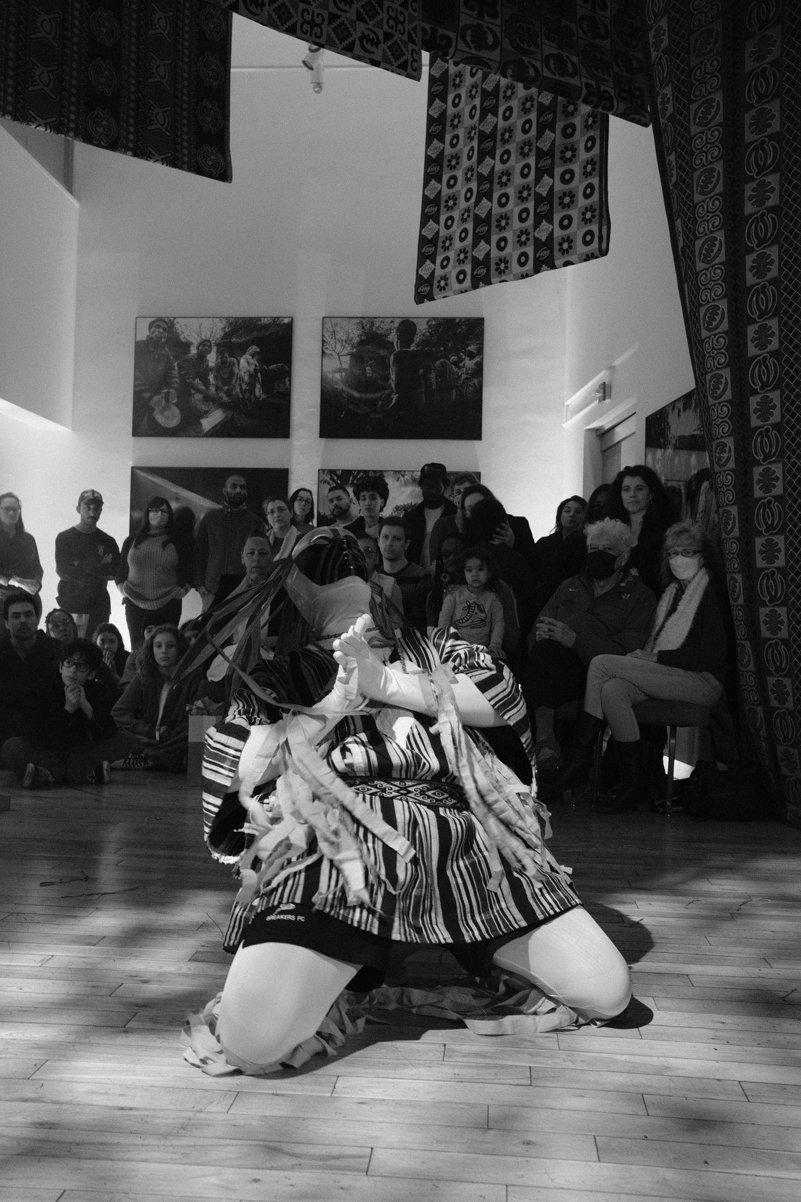 Masked dancer on their knees