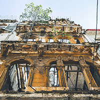 A photograph of the exterior of a dilapidated building. 