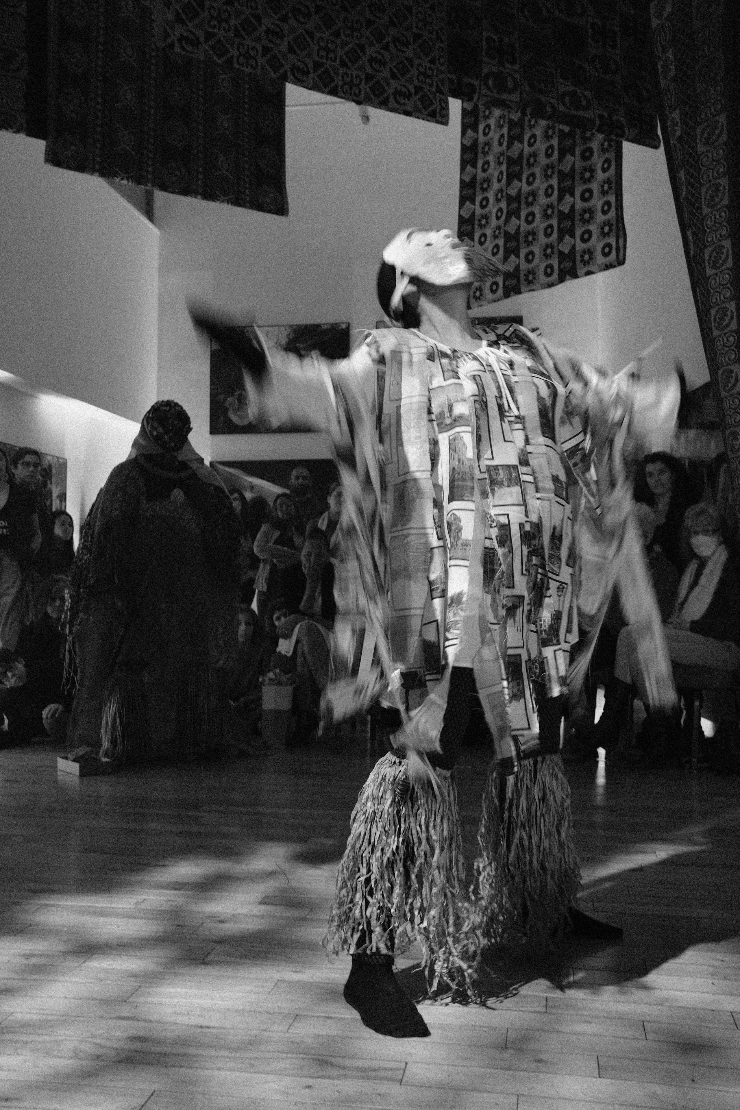 Masked dancer with arms outstretched