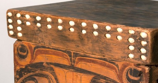 detail of a bentwood box showing lid with inlaid shells
