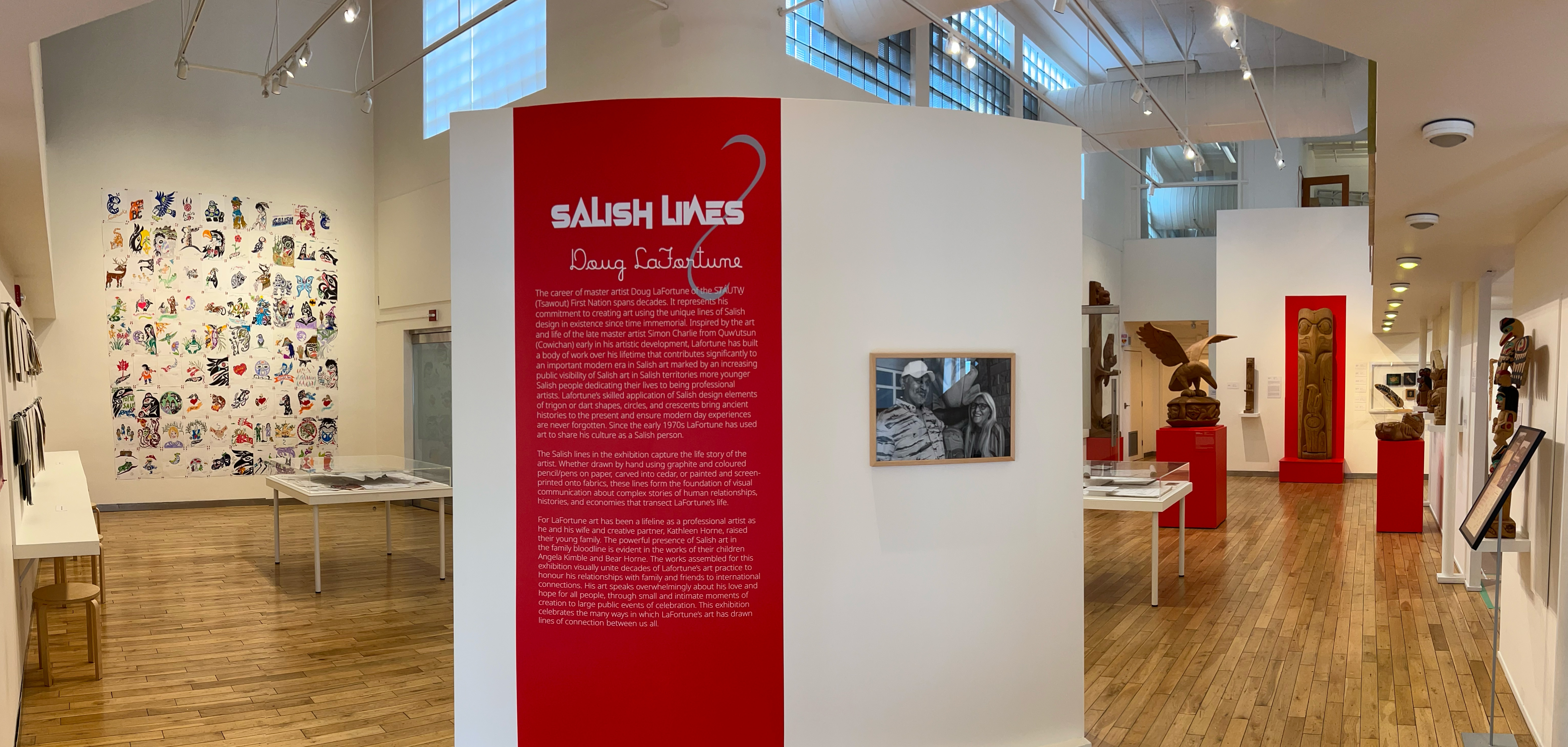 Wide view of the main gallery space for Doug LaFortune's Salish Lines exhibit. Paintings are visible on the walls in the background. 