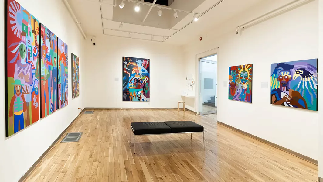 Legacy gallery exhibition space showing colourful paintings