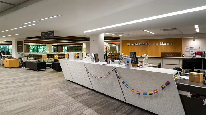View of the Priestly library front desk decorated for Pride