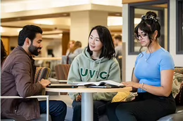 Three students sitting at a table