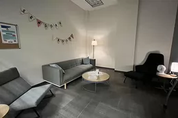 Sensory study space with sofa, dim lighting, and banner that says "sensory room."