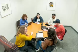 Six people sitting around a table.