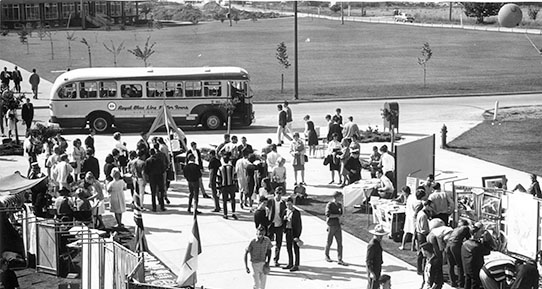 Aerial photo of students walking between club day booths in front of the Student Union Building.