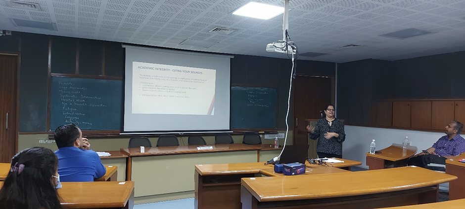 Aditi Gupta presents a slide with the title "Academic Integrity: Citing Your Sources" in a classroom.