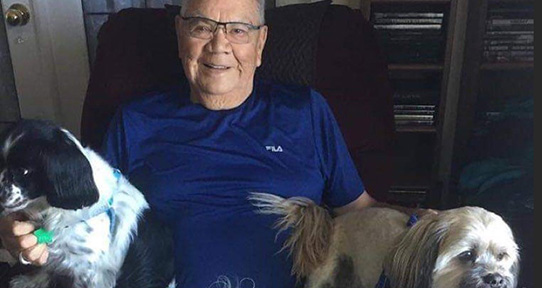 Elder Barney Williams with two dogs