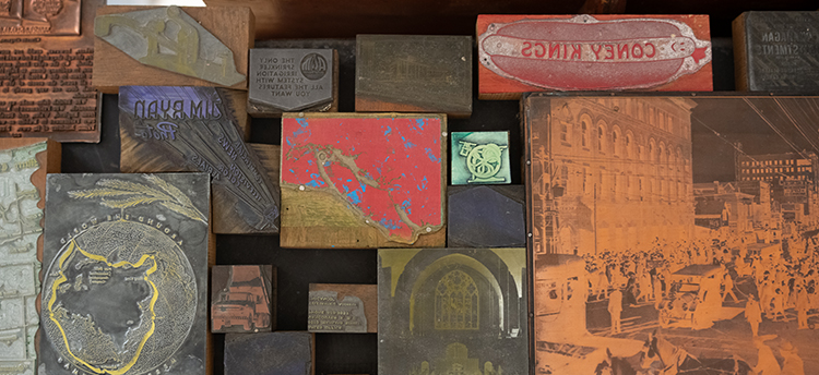 Close-up view of a variety of stamps with different images, including a hot dog and a map of Vancouver Island.