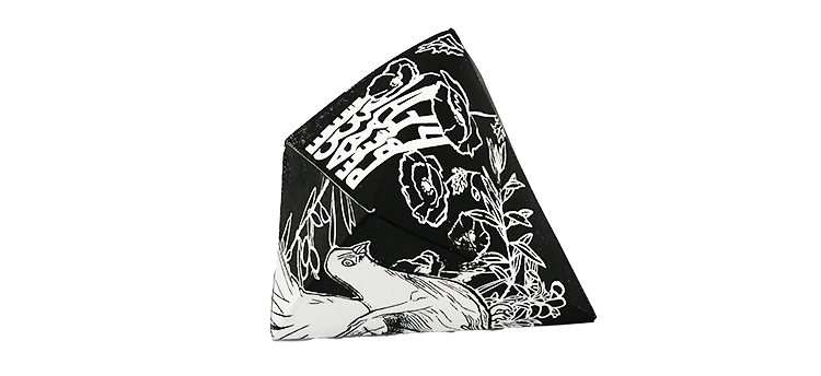 Three-dimensional folder paper object with images of flowers and birds against a black background.