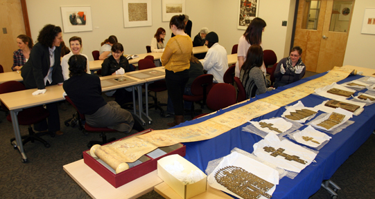 A class of students studies archival materials