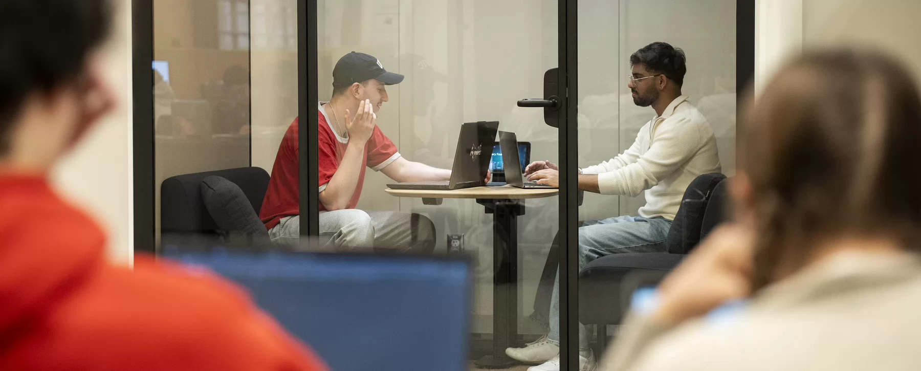 Students working together in library Tek Booths
