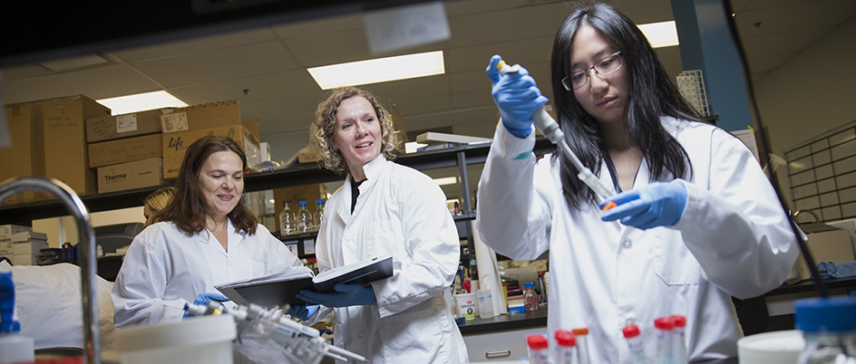 Three people working in a medical science lab