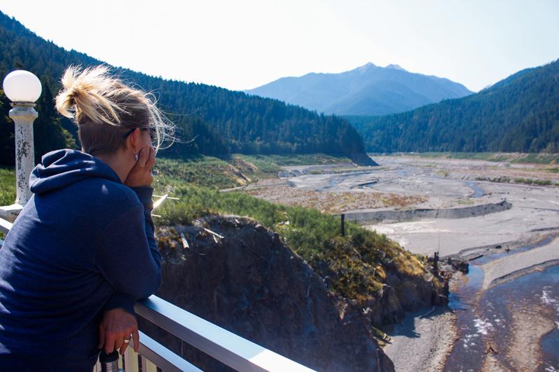 Student looking out over a dam removal site