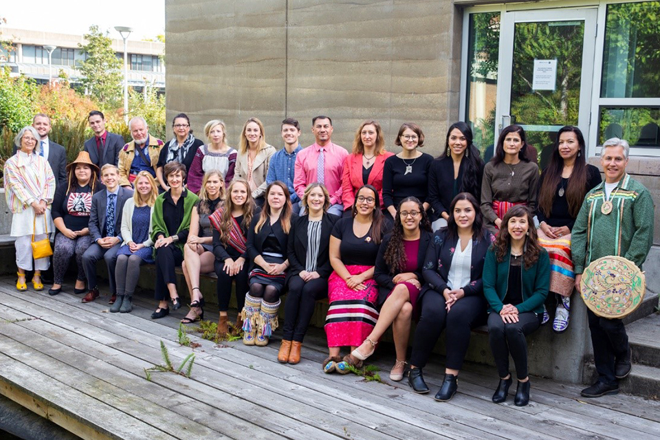 Large group of JID students posing outside of the First Peoples House