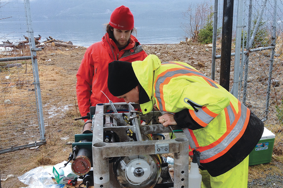 ONC project engineer Ryan Key (in red) and marine equipment specialist Ian Beliveau at work on the Kitamaat Village community observatory platform. Photo: ONC.